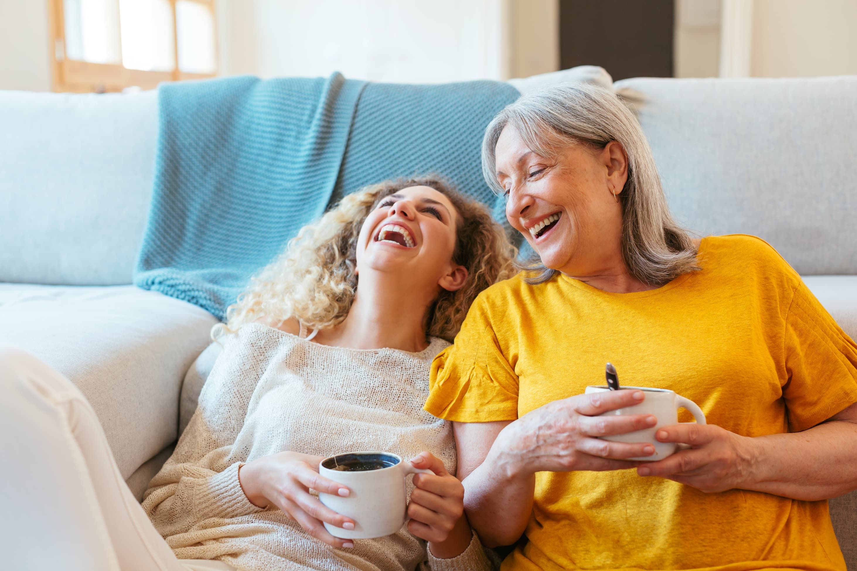 Zwei lachende Frauen mit Kaffee