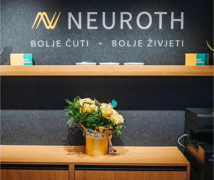Cvijetna dekoracija na polici ispod Neuroth natpisa 
